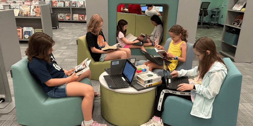 Shallowford Falls students reading books together in the school library
